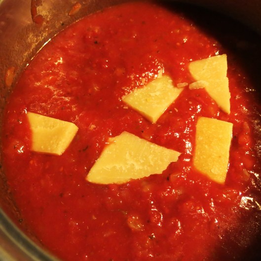 Parmesan Rinds added to Diced Onions and Fennel with Tomatoes