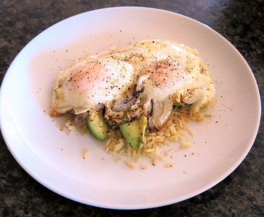 Fried Eggs with Avocado Slices over Garlic Rice