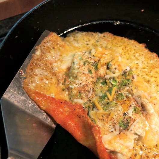 Turning the Cheese over the Eggs for Fried Egg Sandwich with a Crispy Cheese Collar