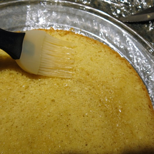 Brushing Lemoncello on Each Layer of Sponge Cake