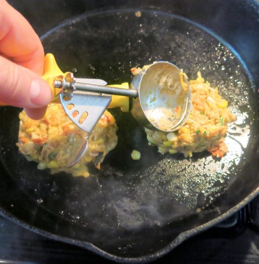 Frying Spicy Corn and Zucchini Cakes with Tomato Bits