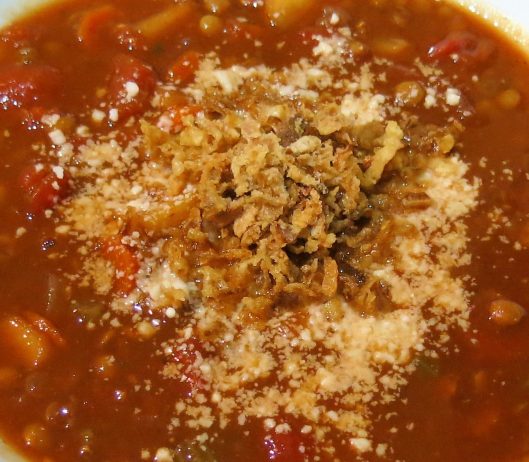 Onion Crunch and Queso Rallado as a garnish for Tomato Soup with Lentils, Carrots & Apple