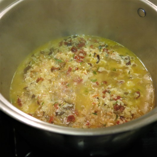Adding the Broth to the Citrus-Laced, Cuban-Style Risotto with Shrimp, Sun-Dried Tomatoes and Mushrooms